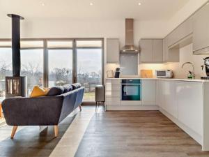 a living room with a couch and a kitchen at 2 Bed in Colchester oc-95941 in East Bergholt +8 photos