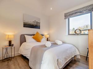 a bedroom with two beds and a window at 2 Bed in Colchester oc-95941 in East Bergholt