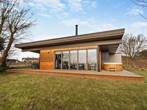 a small house with glass windows on a field at 2 Bed in Colchester oc-95941 in East Bergholt