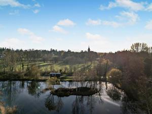 a view of a lake with a church in the distance at 1 Bed in Norwich oc-76493 in East Harling