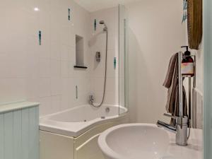 a white bathroom with a tub and a sink at 4 Bed in Boscastle oc-47035 in Boscastle +33 photos