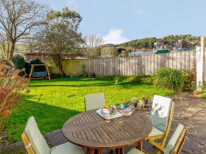 a wooden table and chairs in a yard at 2 Bed in Par- oc-81252 in Saint Blazey