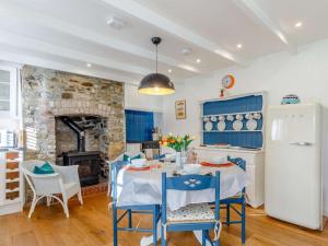 a kitchen with a table and chairs and a fireplace at 2 Bed in Par- oc-81252 in Saint Blazey