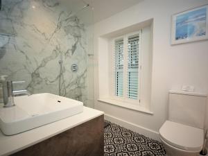 a white bathroom with a sink and a toilet at 2 Bed in Par- oc-81252 in Saint Blazey +9 photos