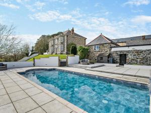 a large swimming pool in front of a house at 2 Bed in Helston oc-41378 in Cury