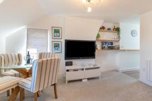 a living room with a television and a table and chairs at 2 Bed in Abersoch oc-p27804 in Abersoch