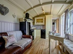a living room with a couch and a kitchen at 1 Bed in Camelford oc-90818 in Camelford +9 photos