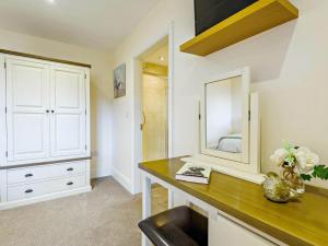 a bedroom with a dressing table and a mirror at 2 Bed in Spilsby oc-91141 in Skendleby +14 photos