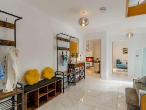 a living room with shelves and a room with a couch at 4 Bed in Bude oc-89355 in Poughill