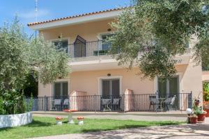 a house with a balcony with tables and chairs at Syrainas studios in Troulos