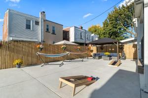 a backyard with a hammock and a fence at Oasis Spacious-Private Parking 16 Beds 29 Guests in Philadelphia