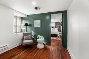 a living room with a chair and a bedroom at Oasis Spacious-Private Parking 16 Beds 29 Guests in Philadelphia