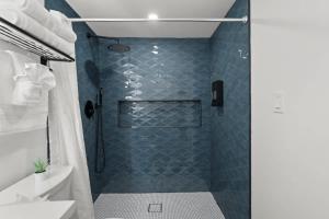 a bathroom with a shower with blue tiles at Oasis Spacious-Private Parking 16 Beds 29 Guests in Philadelphia