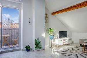 a living room with a large window and a tv at proche lac et centre parking gratuit in Thonon-les-Bains
