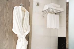 a bathroom with white towels hanging on a wall at Maien Taiba in Medina +31 photos