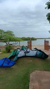 a kite laying on the grass near a body of water at Kite House Barreiras in Macau +19 photos