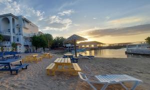 a group of picnic tables and chairs on the beach at Gem in Runaway Bay