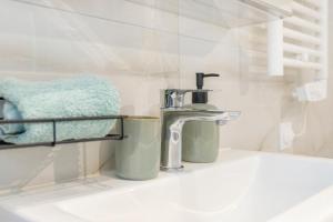 a bathroom sink with a faucet on a counter at proche lac et centre parking gratuit in Thonon-les-Bains +41 photos