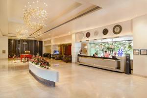 a lobby of a hotel with a waiting area and a restaurant at Radisson Blu Bengaluru Outer Ring Road in Bangalore +139 photos