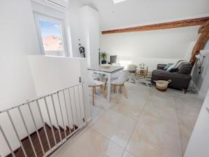 a living room with a staircase and a table at proche lac et centre parking gratuit in Thonon-les-Bains