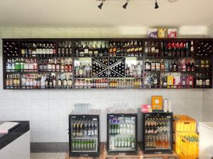 a bar with many bottles of alcohol on the wall at Sienna Beach Hotel - Entebbe in Entebbe