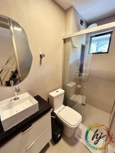 a bathroom with a toilet and a sink and a shower at Mares Cabo Branco 507 in Tambaú +22 photos