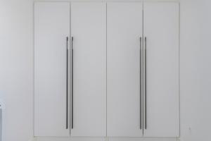 a row of white cabinets with silver handles at proche lac et centre parking gratuit in Thonon-les-Bains