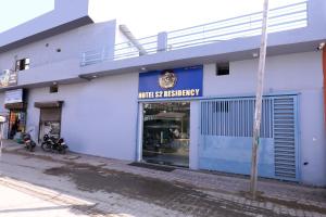 a blue and white building with a store at Hotel S2 Residency Near Railway Station Chandigarh in Chandīgarh