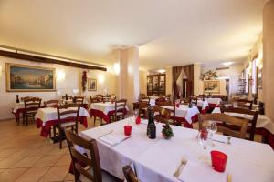 a restaurant with tables and chairs with white table cloth at Locanda Gallo in Dolo +30 photos
