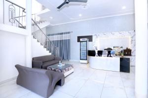 a living room with a couch and a table at Hotel S2 Residency Near Railway Station Chandigarh in Chandīgarh