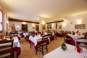 a restaurant with white tables and chairs with red bows at Locanda Gallo in Dolo