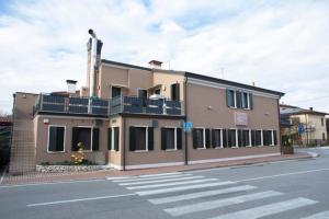 a building on the side of a street at Locanda Gallo in Dolo