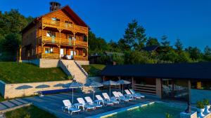a house with a swimming pool next to a building at Villa Panoramic Sovata in Sovata
