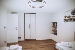 a white room with white doors and wooden floors at Apartmány Orlí in Hranice +50 photos