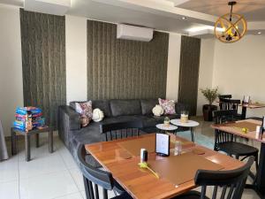 a living room with a couch and tables and chairs at Dukes Chambers in Harrismith