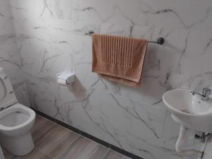 a white bathroom with a toilet and a sink at La Residence D'Almée Apartment and Studio in Praslin +80 photos