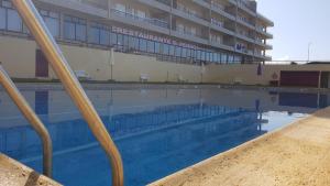 a large swimming pool in front of a building at Al.Fredos in Mindelo