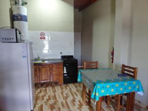 a small kitchen with a table and a refrigerator at catalina n3 in Neuquén