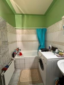 a bathroom with a washing machine and a sink at Eiffel Tower view & Swimming Pool, Cosy appartment - Center in Paris