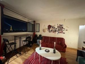 a living room with a red couch and a table at Eiffel Tower view & Swimming Pool, Cosy appartment - Center in Paris