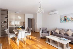 a living room with a couch and a table and chairs at Przno central seaside in Pržno