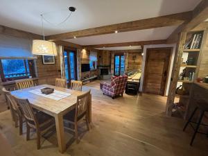 a dining room and living room with a table and chairs at L'Atelier du Temps - Chalet Crammont in Courmayeur +26 photos