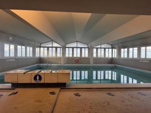 a large indoor swimming pool in a building at Eiffel Tower view & Swimming Pool, Cosy appartment - Center in Paris