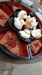a table with two black trays of food with desserts at L'atelier de joakim in Seix