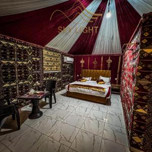 a bedroom with a bed in a tent at Skylight Wadi Rum Camp in Disah