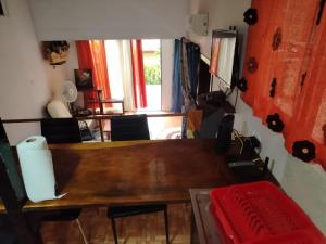 a dining room with a wooden table and chairs at Casa Sol in Sarapiquí