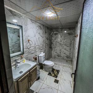 a bathroom with a toilet and a sink at Skylight Wadi Rum Camp in Disah