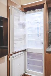 an empty refrigerator with its door open in a kitchen at 한 스위트 서울 in Seoul +151 photos