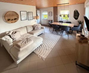 a living room with a couch and a table at ZweiundMeer Bungalow 1 in Wiek auf Rügen