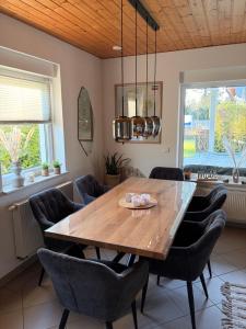a dining room with a wooden table and chairs at ZweiundMeer Bungalow 1 in Wiek auf Rügen +13 photos